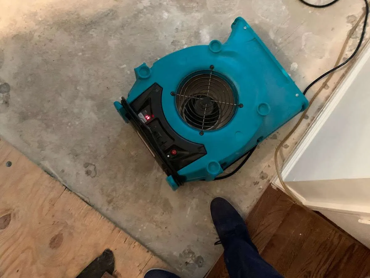Air mover drying subfloor during Commercial Water Damage Restoration in Rancho Cucamonga